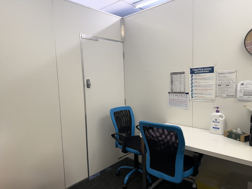 The private consultation room, with a desk and two chairs behind a closing door