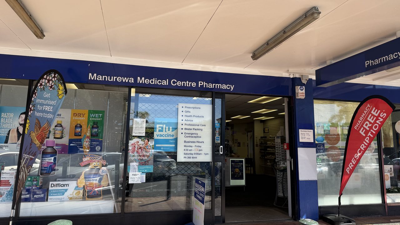 The pharmacy shopfront under the veranda, with the blue Manurewa Medical Centre Pharmacy sign above the windows